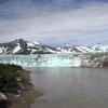 The Copper River sonar site is downstream of Miles Lake Glacier and Million Dollar Bridge, and upstream of Childs Glacier. In this photograph taken from the bridge, Childs Glacier is pictured in the background.
The sonar site’s left-bank shelter and the top of a submerged sonar transducer is 
pictured in the lower left-hand corner.